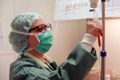 Close-up of doctor holding iv drip