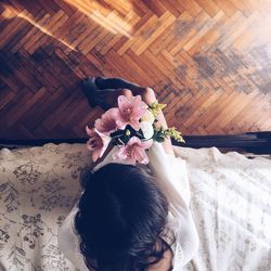 Directly above shot of woman holding flower bouquet