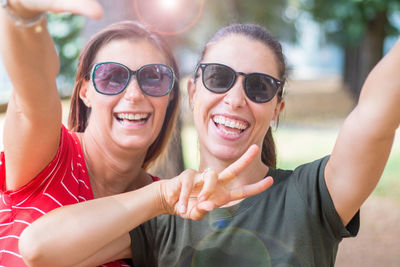 Portrait of smiling young woman wearing sunglasses