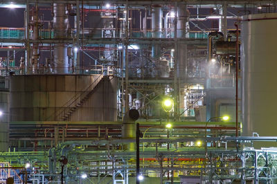 Low angle view of illuminated industry at night