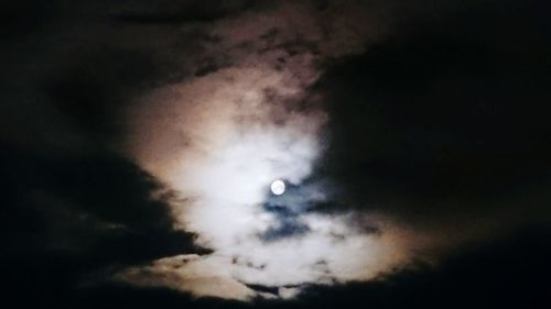 Low angle view of cloudy sky at night