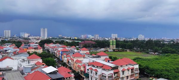High angle view of houses and buildings against sky
