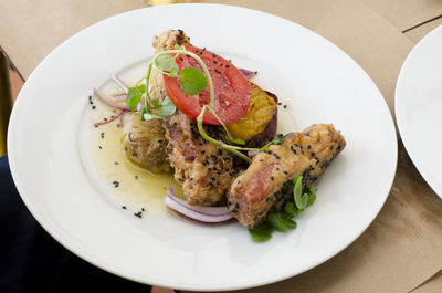 High angle view of tuna fish served in plate on table at restaurant