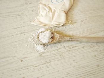 High angle view of sea salt on a wooden spoon