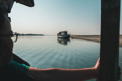 Man in sea against clear sky