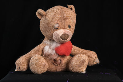 Close-up of stuffed toy against black background