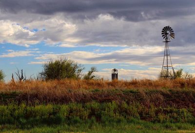 Windmill on field against sky