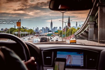 Cars on road with buildings in background