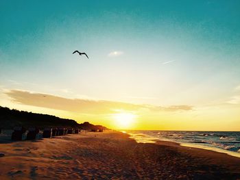 Scenic view of beach against sky during sunset