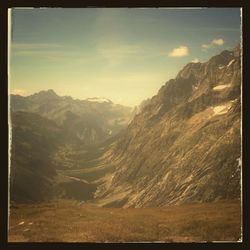 Scenic view of mountains against cloudy sky
