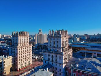 High angle view of buildings against blue sky