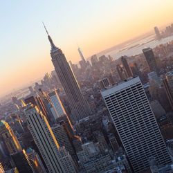 Aerial view of buildings in city during sunset