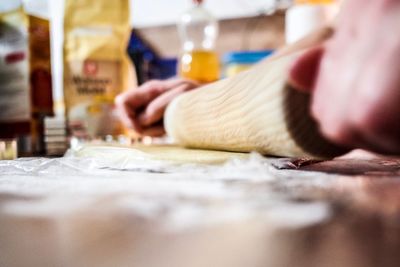 Close-up of person preparing food on table