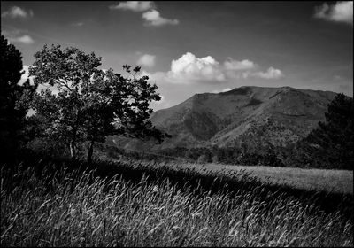 Scenic view of mountains against cloudy sky