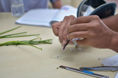 Cropped image of man working on table