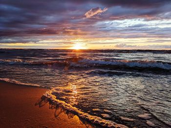 Scenic view of beach against sky during sunset