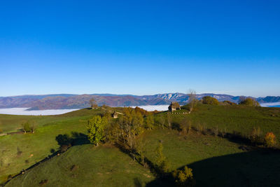 Scenic view of mountains against clear blue sky