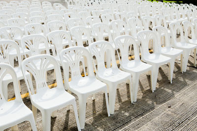 Empty chairs and tables in row