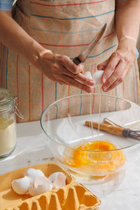 Cropped hands of man preparing food on table