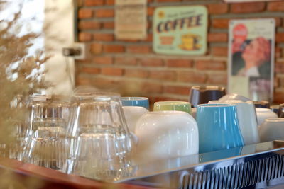 Various coffee cups in container at shop