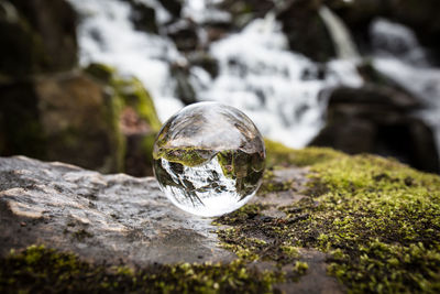 Close-up of crystal ball on rock