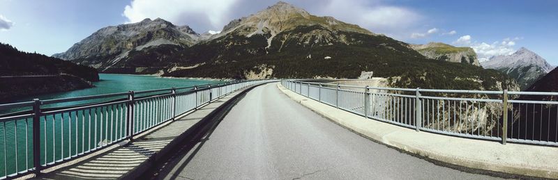 Bridge amidst mountains against sky