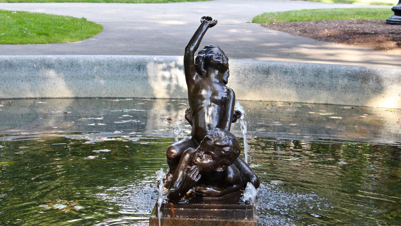 CLOSE-UP OF FOUNTAIN WITH STATUE IN WATER