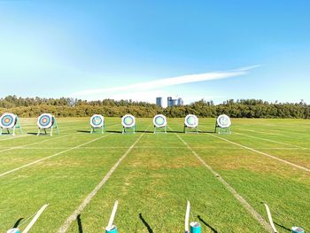 Hay bales on field against sky