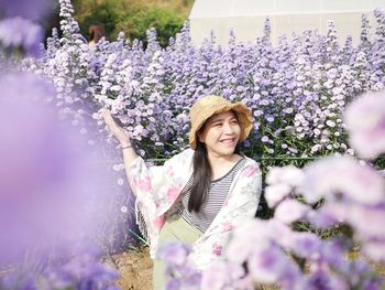 Portrait of smiling woman with purple flowers