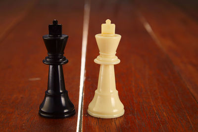 Close-up of chess pieces on wooden table