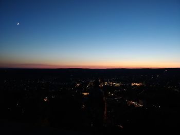 Silhouette buildings against clear sky during sunset