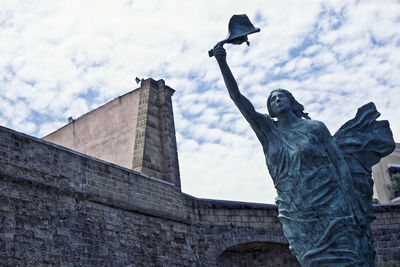 Low angle view of statue against sky