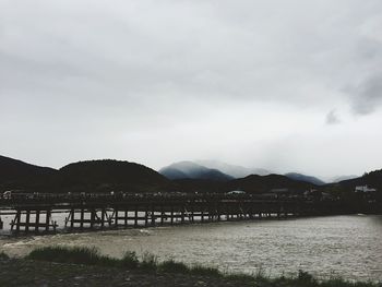 Scenic view of river and mountains against sky