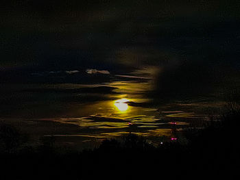 Silhouette landscape against sky at night