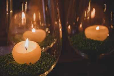 Close-up of illuminated candles on table