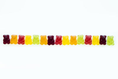 Close-up of multi colored candies against white background