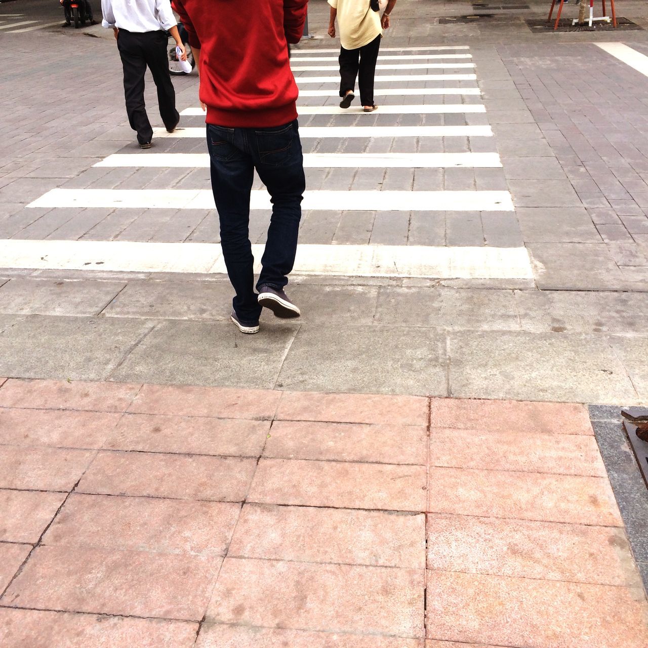 low section, walking, person, men, lifestyles, street, city life, rear view, standing, leisure activity, sidewalk, on the move, city, zebra crossing, footpath