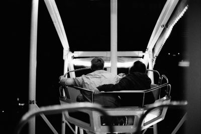 Rear view of man sitting on seat in train