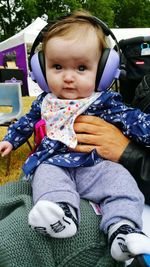 Portrait of cute baby girl sitting on sofa