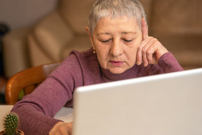 Young man using laptop while sitting at home