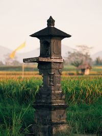 View of windmill on field against clear sky