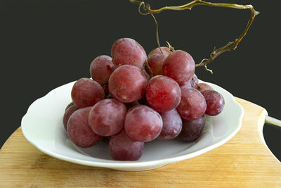 High angle view of grapes in bowl on table