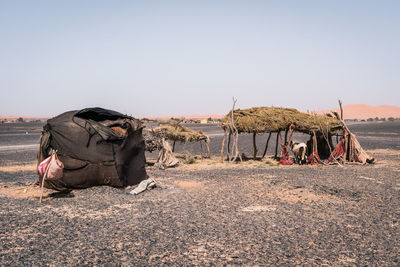 Panoramic view of people on desert against clear sky