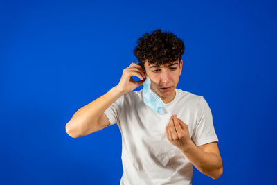 Man wearing mask against blue background