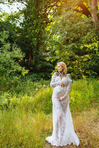 Woman standing by tree