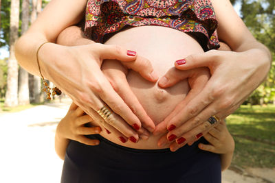 Midsection of woman touching hands