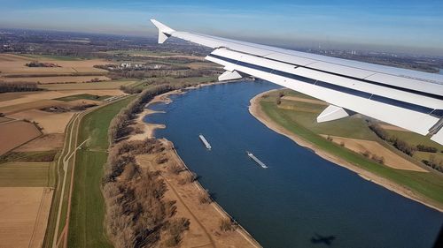 Aerial view of airplane flying over rhine with patchwork landscape