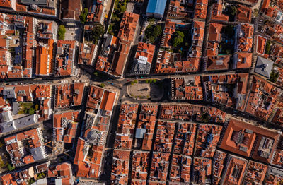 Overhead aerial of red roofs of buildings in historic center of city in lisbon, portugal.