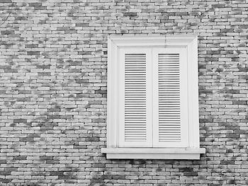 Full frame shot of closed window on brick wall of building