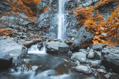 Scenic view of waterfall in forest during autumn